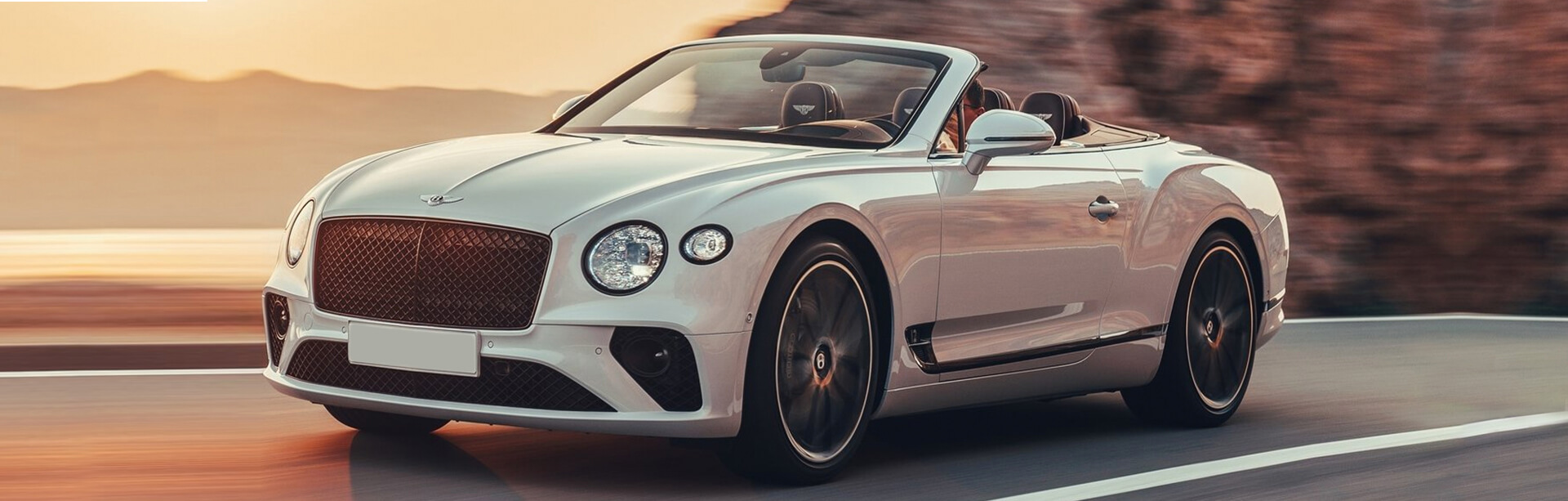 European Import Service Specializing in Bentley Service in Newport Beach. White Bentley Convertable Driving
